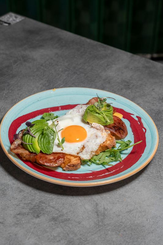 Toast with avocado, bacon, cheddar and fried egg