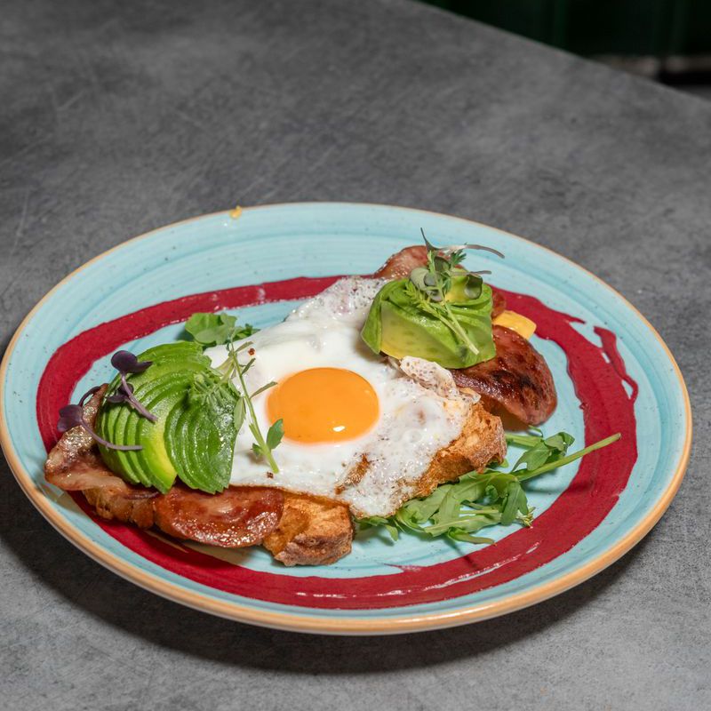 Toast with avocado, bacon, cheddar and fried egg