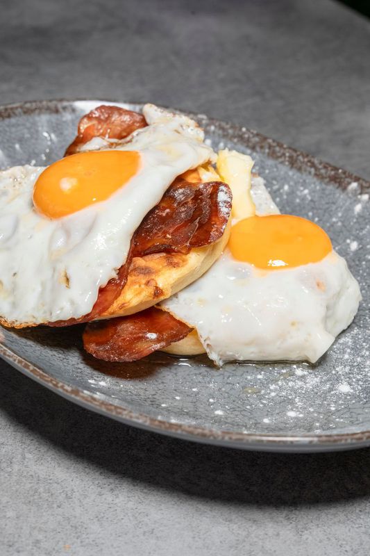 Pancakes with honey, egg and bacon