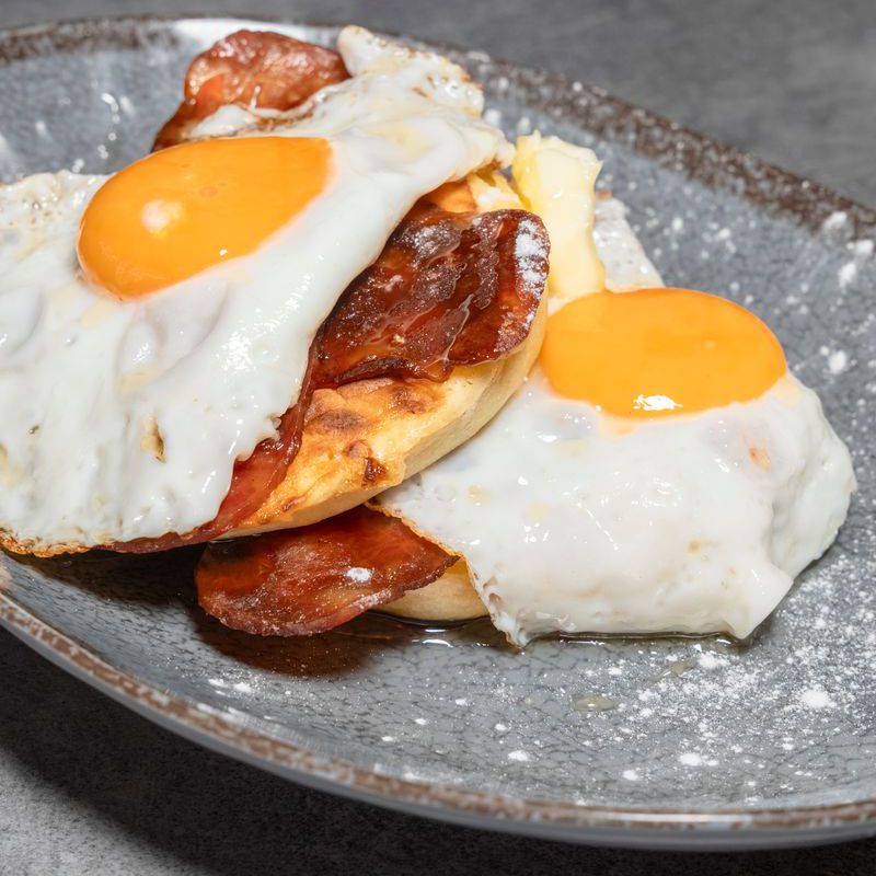 Pancakes with honey, egg and bacon